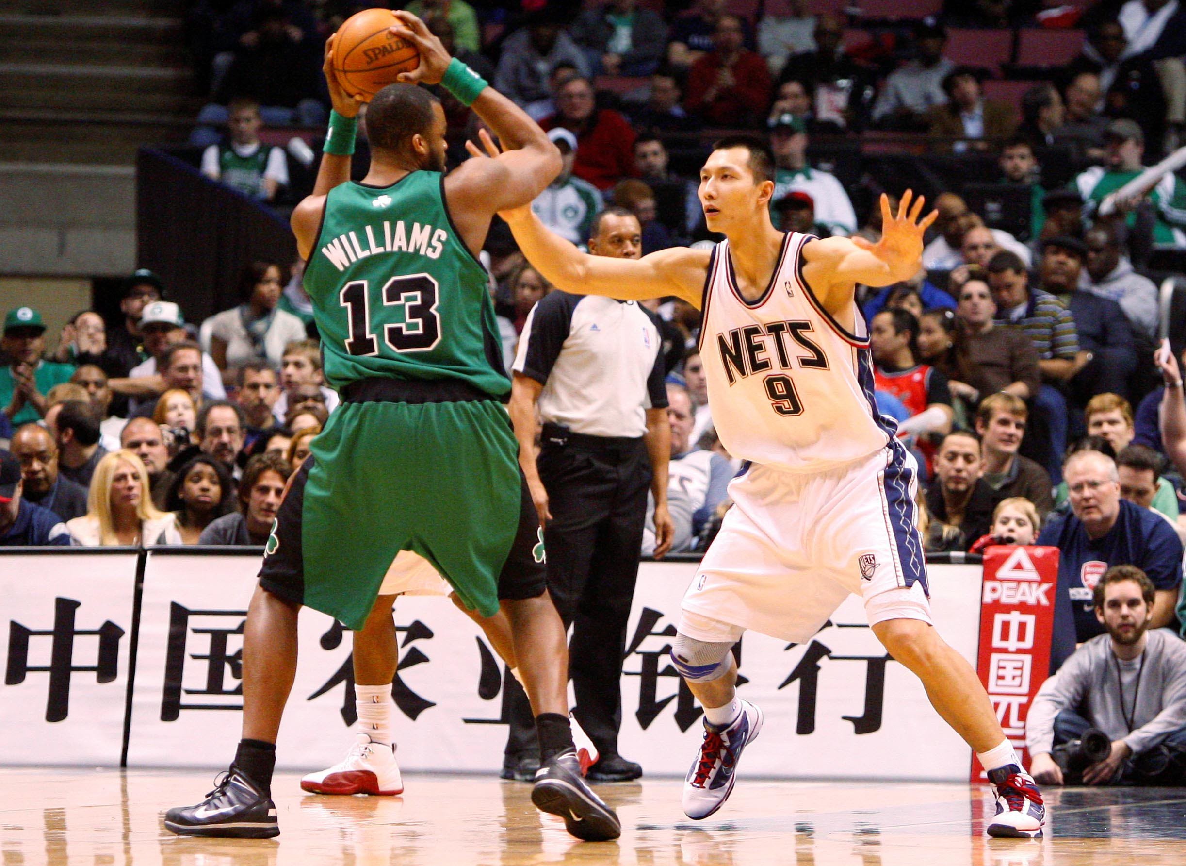 Jan 13, 2010; East Rutherford, NJ, USA; New Jersey Nets forward Yi Jianlian (9) guards Boston Celtics forward Shelden Williams (13) during the first half at the Izod Center. Mandatory Credit: Jim O'Connor-USA TODAY Sports
