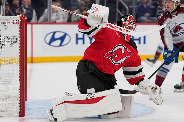 New Jersey Devils goaltender Jake Allen defends the goal during the first period of an NHL hockey game against the Colorado Avalanche in Newark, N.J., Tuesday, Oct. 20, 2026. (AP Photo/Seth Wenig)