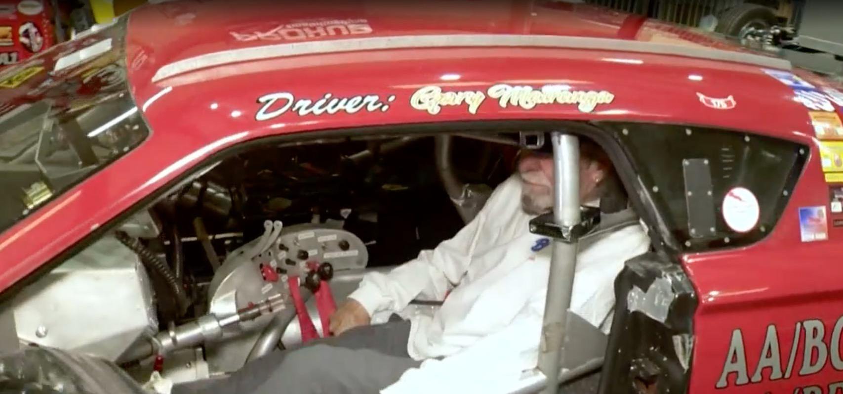Gary Matranga sitting in the driver's seat of his race car.