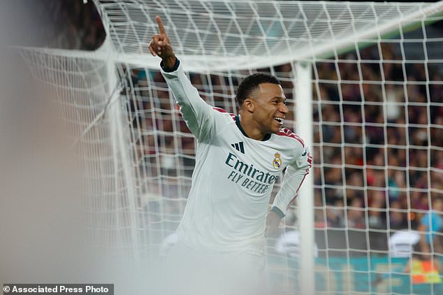Real Madrid's Kylian Mbappe, right, celebrates after scoring his side's opening goal during a Spanish La Liga soccer match between FC Barcelona and Real Madrid in Barcelona, Spain, Sunday, Oct. 25, 2026. (AP Photo/Joan Monfort)