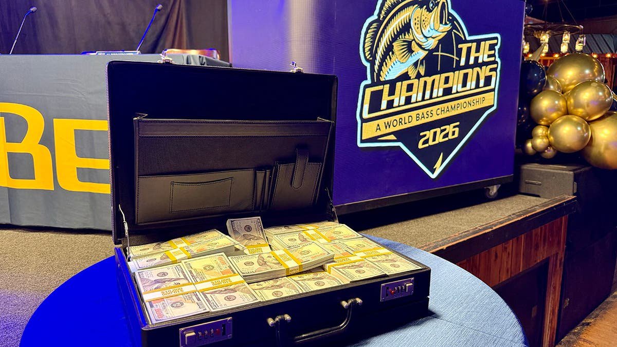 suitcase full of money in front of The Champions logo