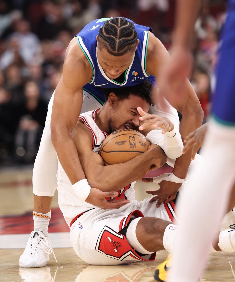 Bulls guard Tre Jones motions for a timeout as Timberwolves forward Jaylen Clark smothers Swain in the second quarter of a preseason game at the United Center on Oct. 16, 2026, in Chicago. (John J. Kim/Chicago Tribune)