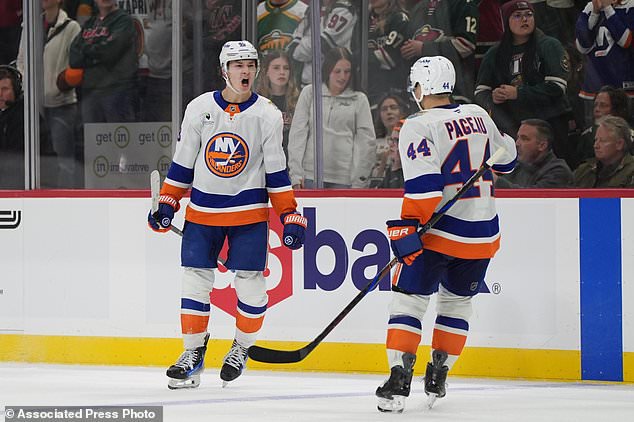 New York Islanders defenseman Matthew Schaefer, left, celebrates next to center Jean-Gabriel Pageau (44) after scoring the winning goal during overtime of an NHL hockey game against the Minnesota Wild, Thursday, Oct. 29, 2026, in St. Paul, Minn. (AP Photo/Abbie Parr)