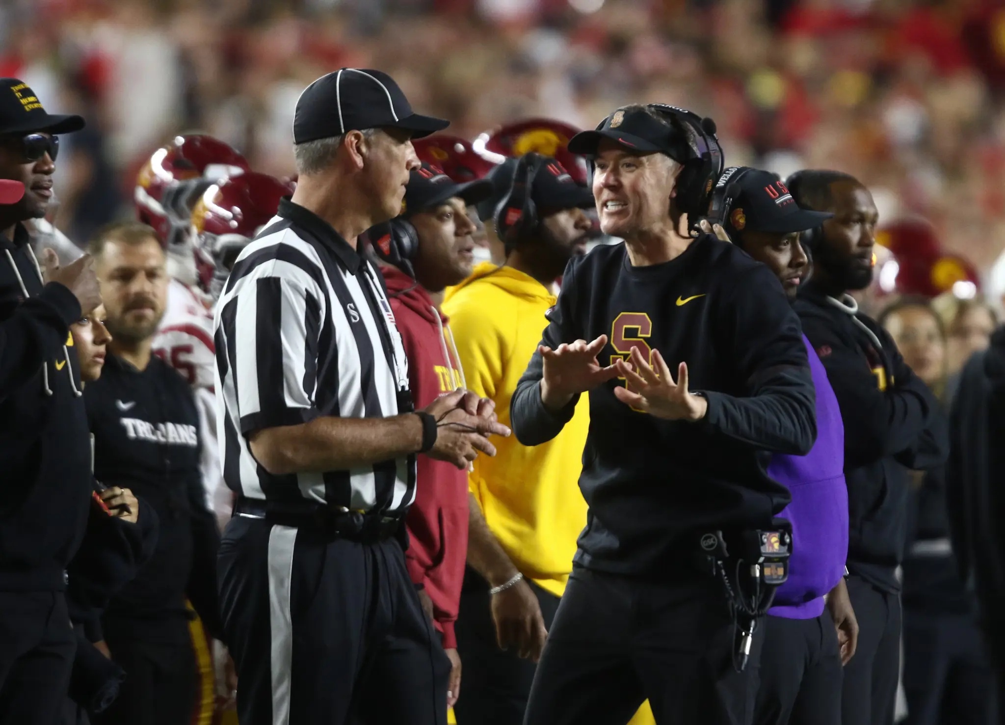 USC football coach Lincoln Riley argues with a referee during a game against Wisconsin.