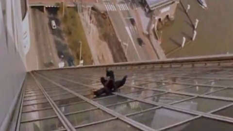 Jackie Chan sliding down building