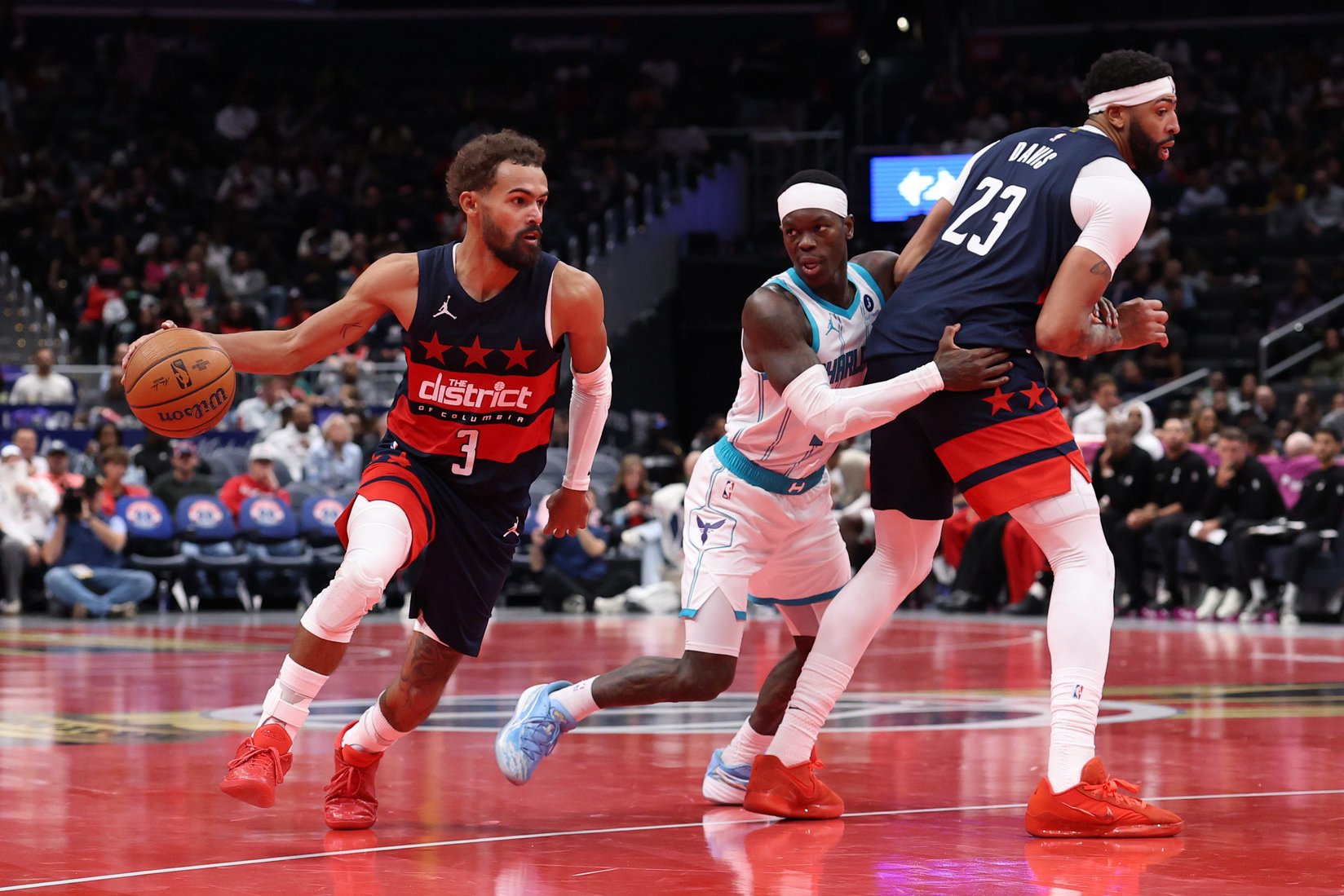 Oct 30, 2026; Washington, District of Columbia, USA; Washington Wizards forward AJ Dybantsa Washington Wizards guard Trae Young (3) dribbles the ball past Charlotte Hornets guard Dennis Schroder (17) and Wizards forward Anthony Davis (23) in the second half in an NBA Cup game at Capital One Arena. Mandatory Credit: Geoff Burke-Imagn Images