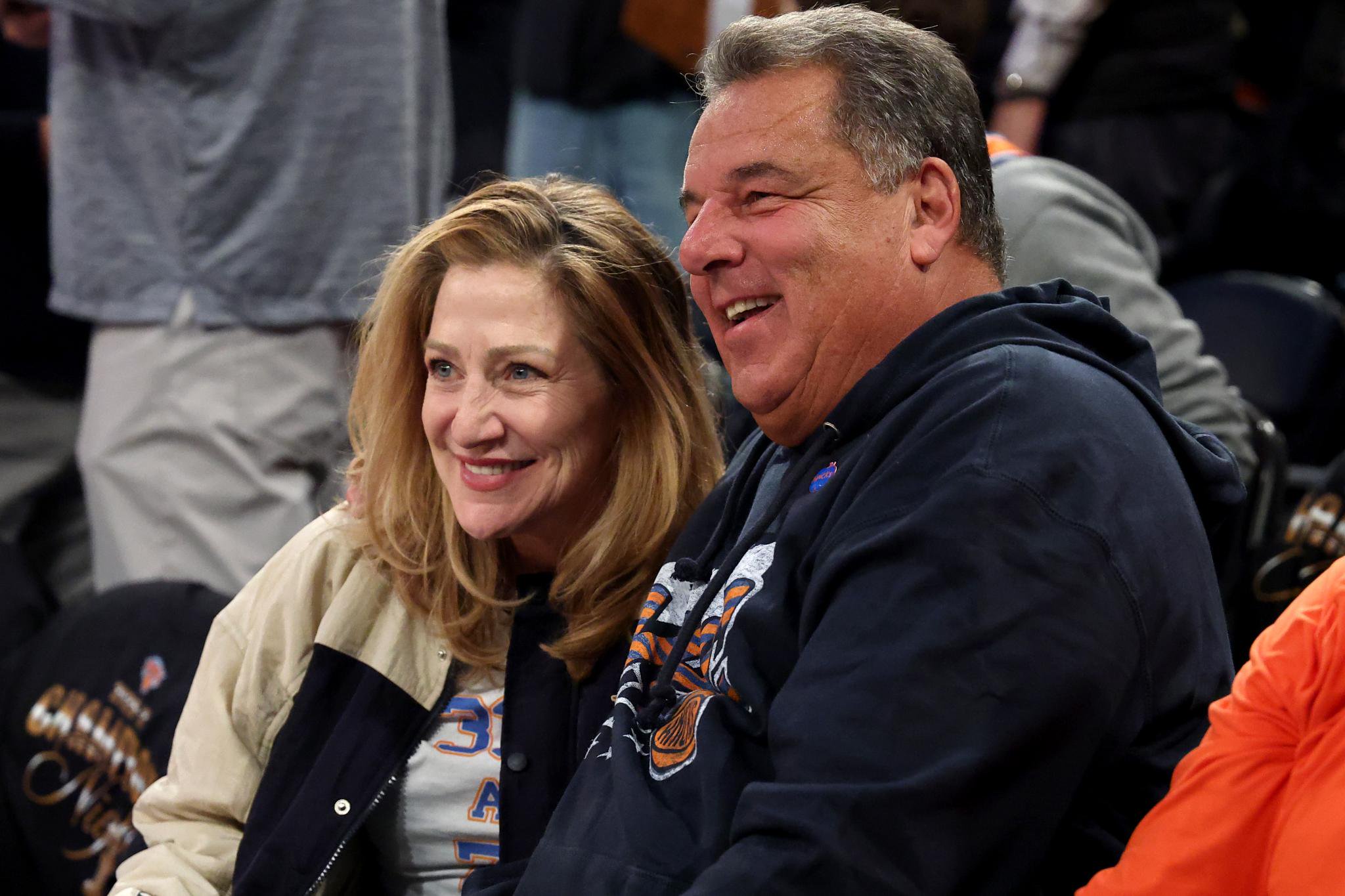 Edie Falco and Steve Schirripa smiling while sitting in the audience.