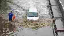 Vehicles wade through a waterlogged stretch during rain on the NH-48 service road near Narsinghpur village foot-over-bridge, in Gurugram on June 28. (Parveen Kumar/HT)