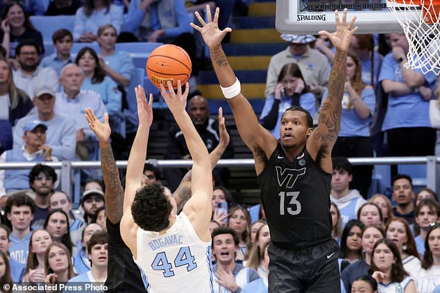 FILE - North Carolina guard Luka Bogavac (44) shoots as Virginia Tech forward Amani Hansberry (13) defends during the second half of an NCAA college basketball game Saturday, Feb. 28, 2026, in Chapel Hill, N.C. (AP Photo/Chris Seward,File)