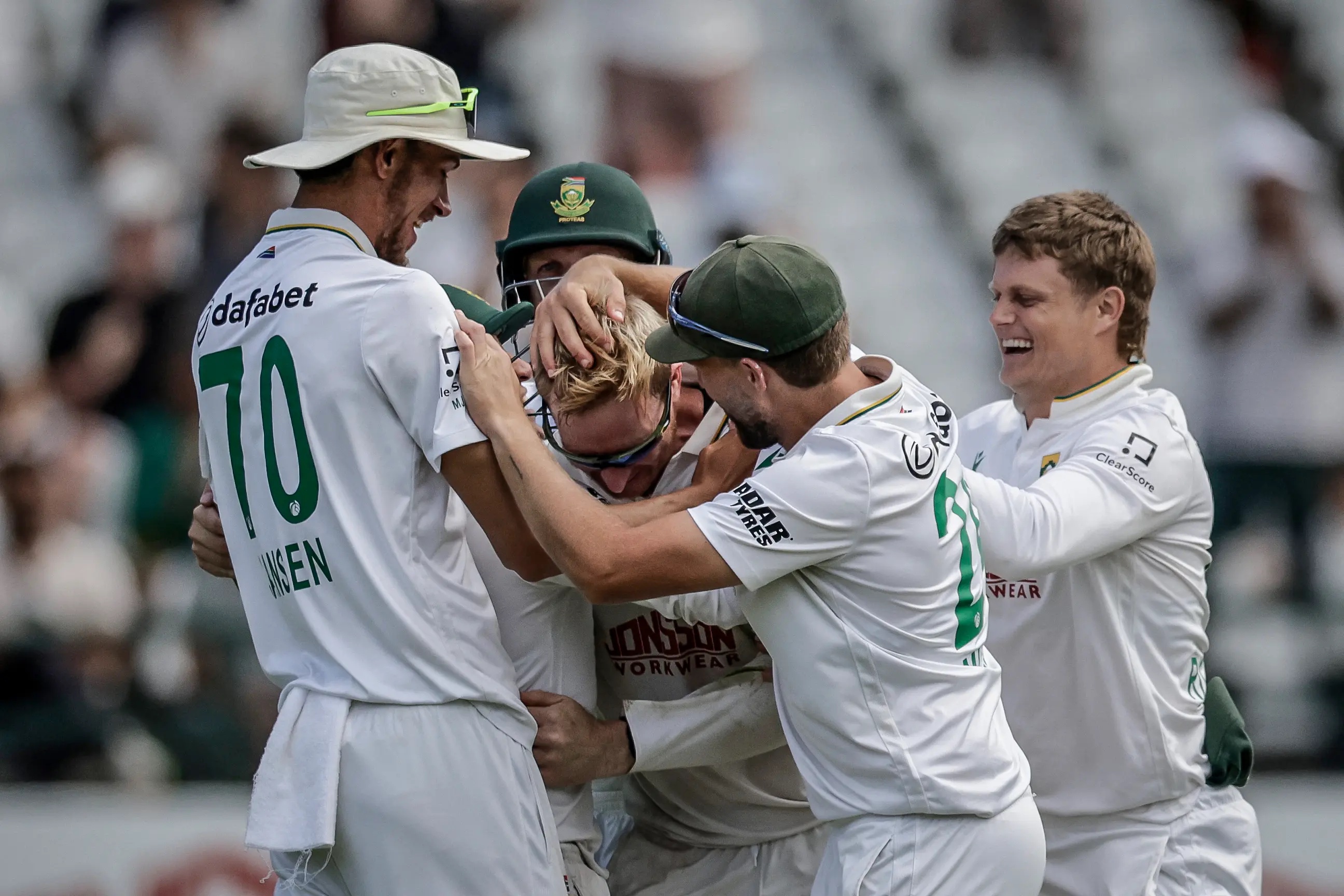 Player of the match Simon Harmer (c) is congratulated by teammates after taking the wicket of Australia's Josh Hazlewood on day five of the third Test match between South Africa and Australia at Newlands stadium in Cape Town on October 31, 2026. 