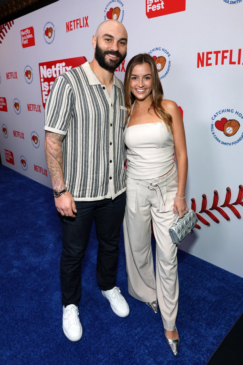 Tanner Scott and Maddie Scott pose on a blue carpet in front of a backdrop featuring Netflix and Catching Hope logos.