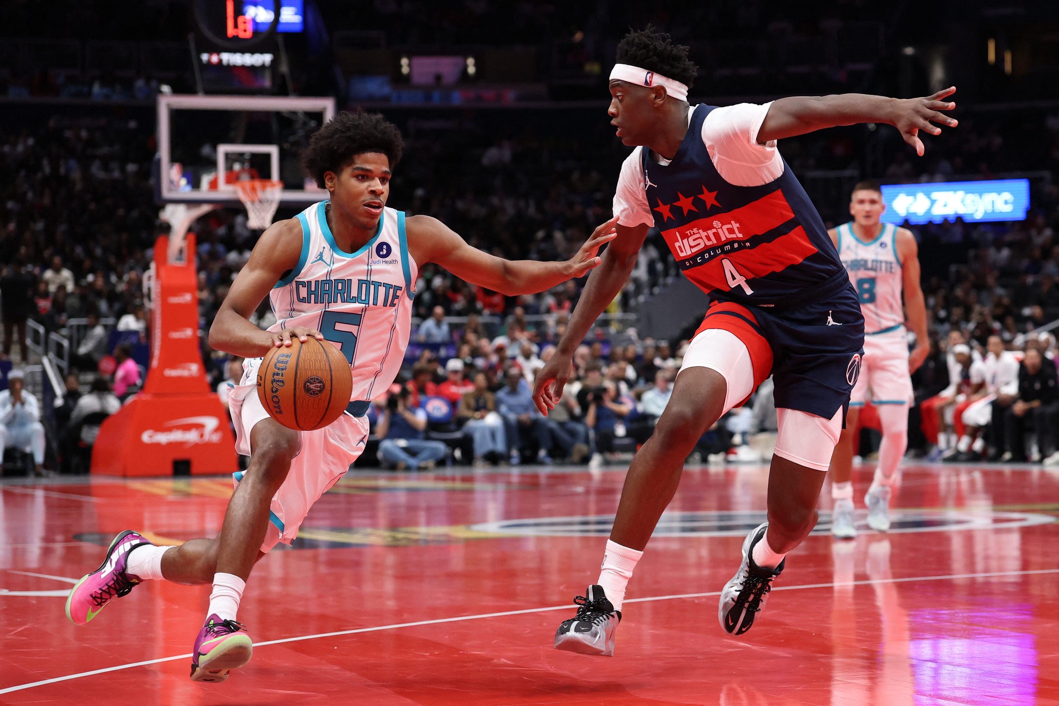 Oct 30, 2026; Washington, District of Columbia, USA; Charlotte Hornets guard Christian Anderson (5) drives to the basket as Washington Wizards forward AJ Dybantsa (4) defends in the first half in an NBA Cup game at Capital One Arena. Mandatory Credit: Geoff Burke-Imagn Images
