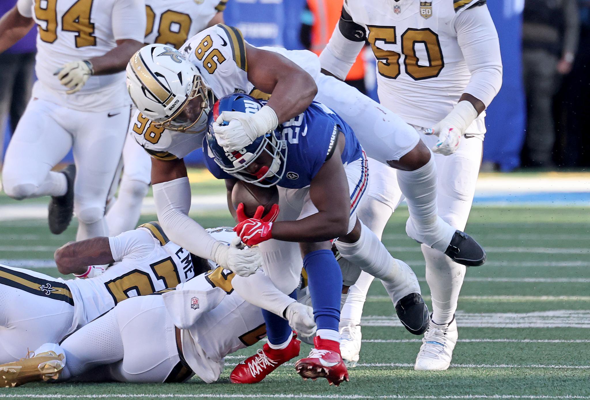 New Orleans Saints defensive end Tyree Wilson (98) tackles New York Giants running back Devin Singletary (26) during the fourth quarter of an NFL football game at MetLife Stadium in East Rutherford, N.J., Sunday, Oct. 18, 2026.