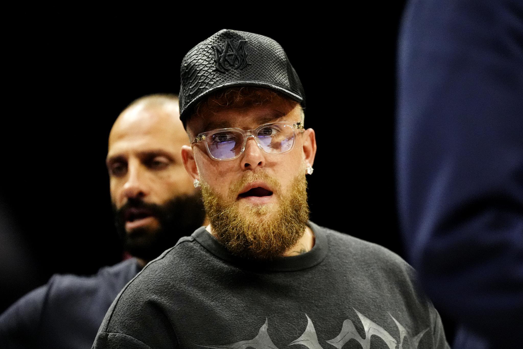 Jake Paul wearing glasses and a cap.