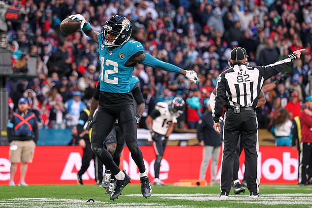 Jacksonville Jaguars wide receiver Travis Hunter (12) celebrates after making an interception during an NFL football game against Houston Texans in London, Sunday, Oct. 18, 2026. (AP Photo/Ian Walton)