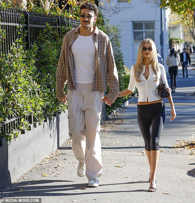 AFL's 'hottest wag' Chelsea Becirevic, seen with partner Ivan Soldo, shared her condolences
