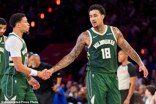 Milwaukee Bucks' Ryan Rollins, left, celebrates his basket with Kyle Kuzma, right, during the first half of an NBA basketball game against the Philadelphia 76ers, Saturday, Oct. 24, 2026, in Philadelphia. (AP Photo/Chris Szagola)