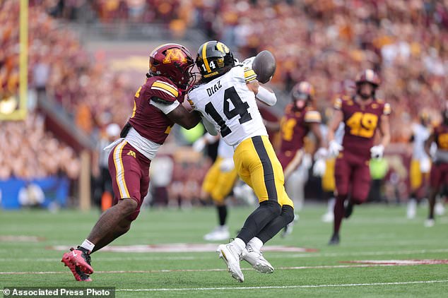 Minnesota defensive back Aydan West, left, breaks up a pass intended for Iowa wide receiver Tony Diaz (14) during the first half of an NCAA college football game Saturday, Oct. 24, 2026, in Minneapolis. (AP Photo/Bailey Hillesheim)