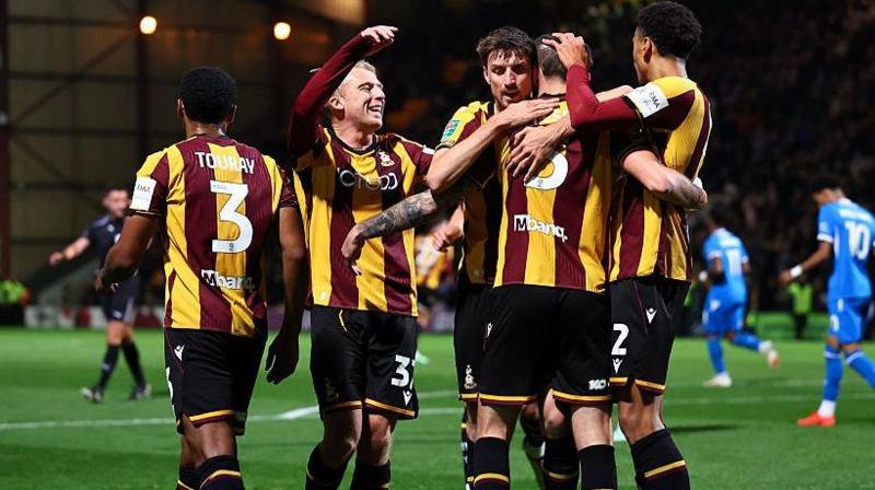 Macaulay Gillesphey is congratulated by his Bradford City team-mates after giving the Bantams the lead against Peterborough United