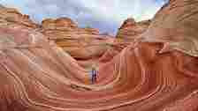 Getty Images Man standing in red streak canyon (Credit: Getty Images)