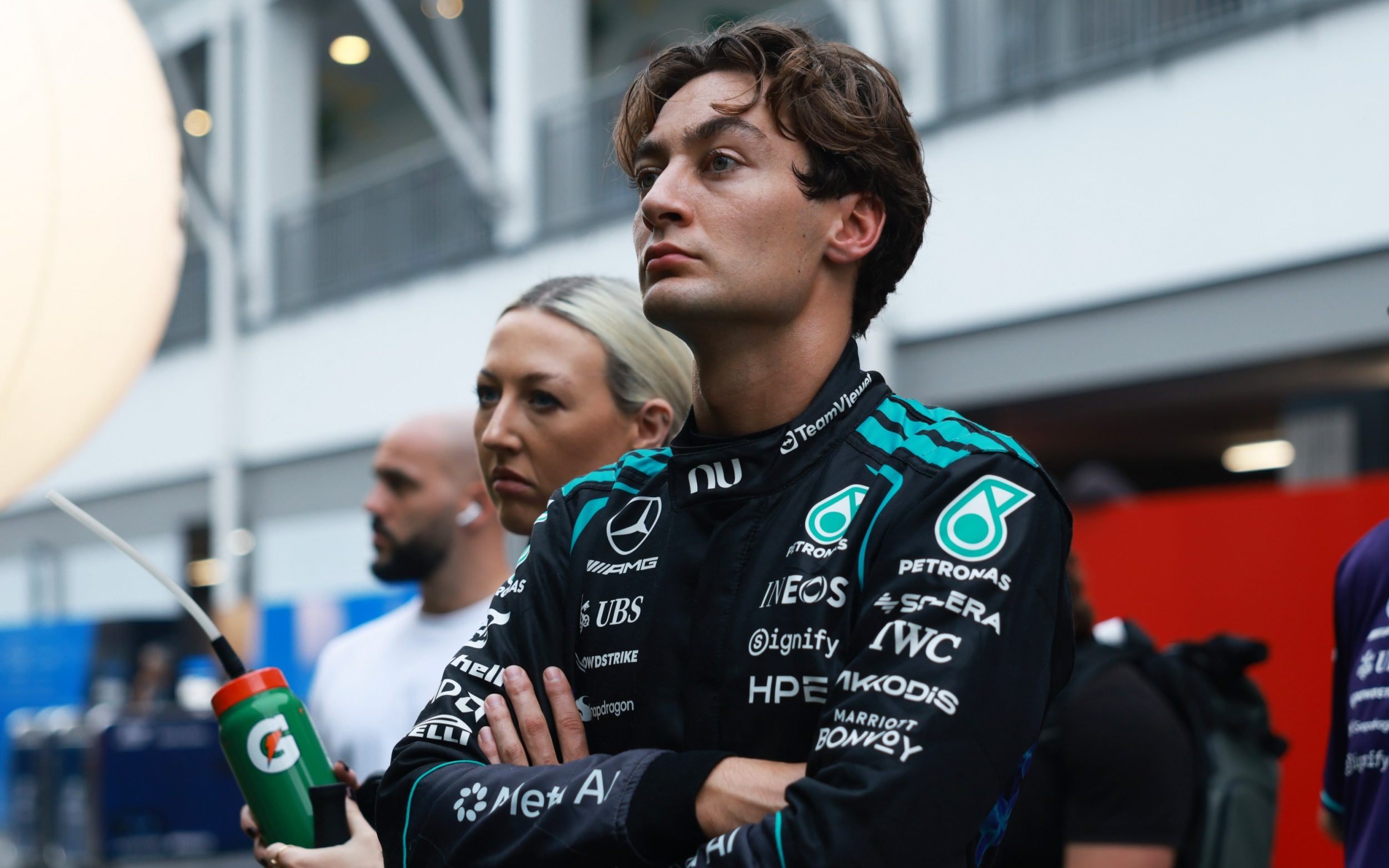 George Russell looks on in the pitlane