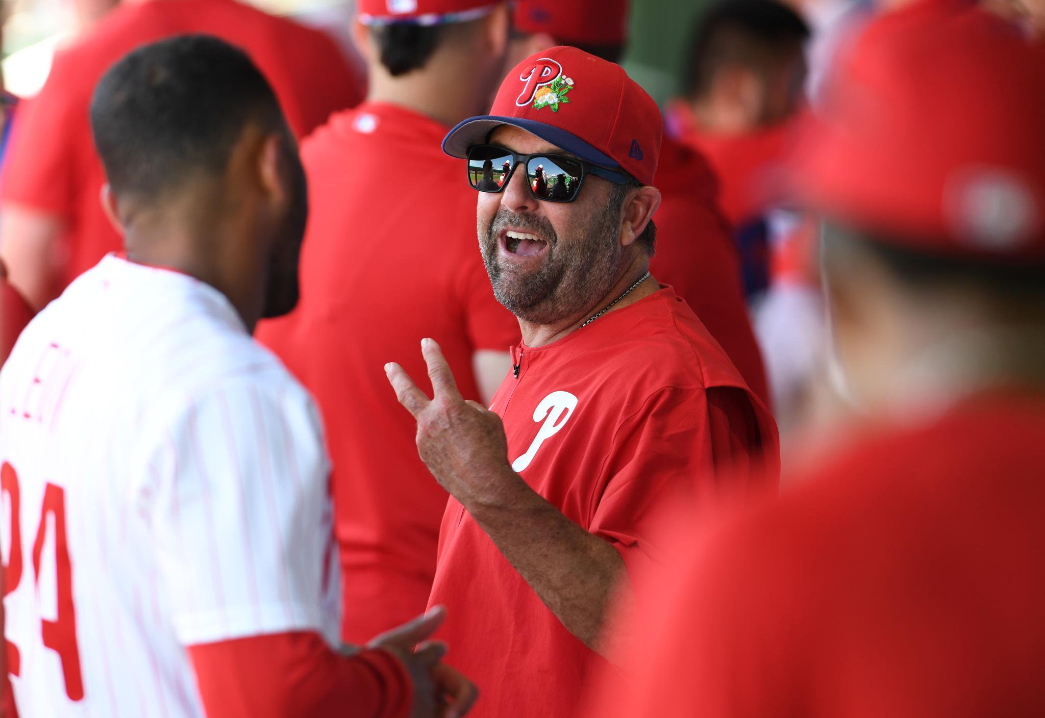 Hitting coach Kevin Long chats with Pedro León #24 of the Philadelphia Phillies during a spring training game against the New York Yankees at BayCare Ballpark on March 10, 2026 in Clearwater, Florida