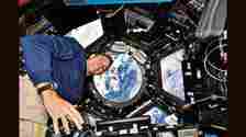 NASA astronaut Josh Cassada photographs Earth from ISS’s seven-window cupola or viewing deck, in 2022. (NASA)