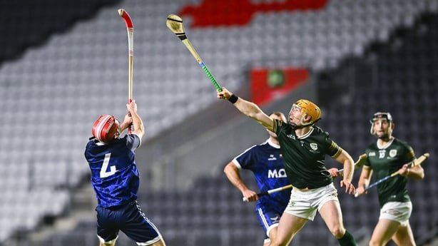 Andrew Ormond of Ireland in action against Duncan Matheson of Scotland during the 2026 Hurling/Shinty International match between Ireland and Scotland at SuperValu Páirc Uí Chaoimh in Cork
