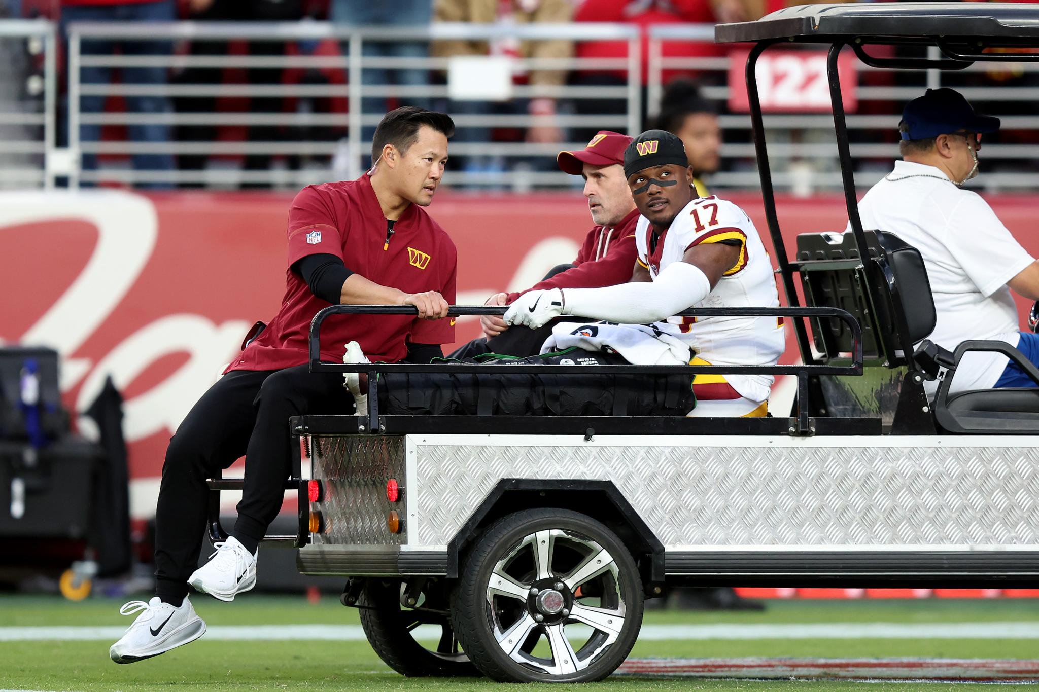 Terry McLaurin of the Washington Commanders being carted off the field on a medical cart.