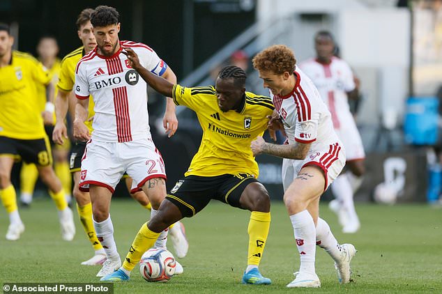 Columbus Crew's Sekou Bangoura, center, keeps the ball away from Toronto FC's Jonathan Osorio, left, and Josh Sargent during the first half of an MLS soccer match, Saturday, Oct. 24, 2026, in Columbus, Ohio. (AP Photo/Jay LaPrete)