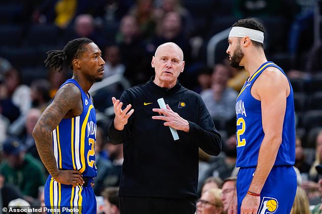 Indiana Pacers head coach Rick Carlisle, center, talks with Aaron Nesmith, left, and Larry Nance Jr., right, during the first half of an NBA basketball game against the Milwaukee Bucks, Monday, Oct. 26, 2026, in Milwaukee. (AP Photo/Kayla Wolf)