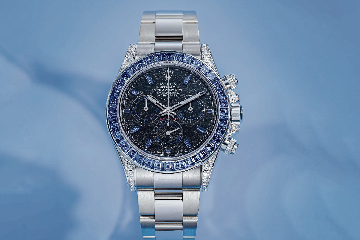 Close-up of a luxurious Rolex Daytona watch with a black dial, sapphire bezel, and diamond-set lugs.