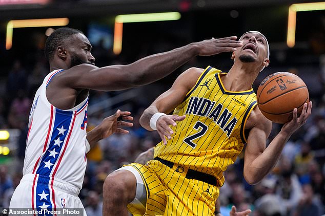Indiana Pacers guard Andrew Nembhard (2) shoots in front of Philadelphia 76ers guard Jaylen Brown (7) during the first half of an NBA basketball game in Indianapolis, Wednesday, Oct. 28, 2026. (AP Photo/Michael Conroy)