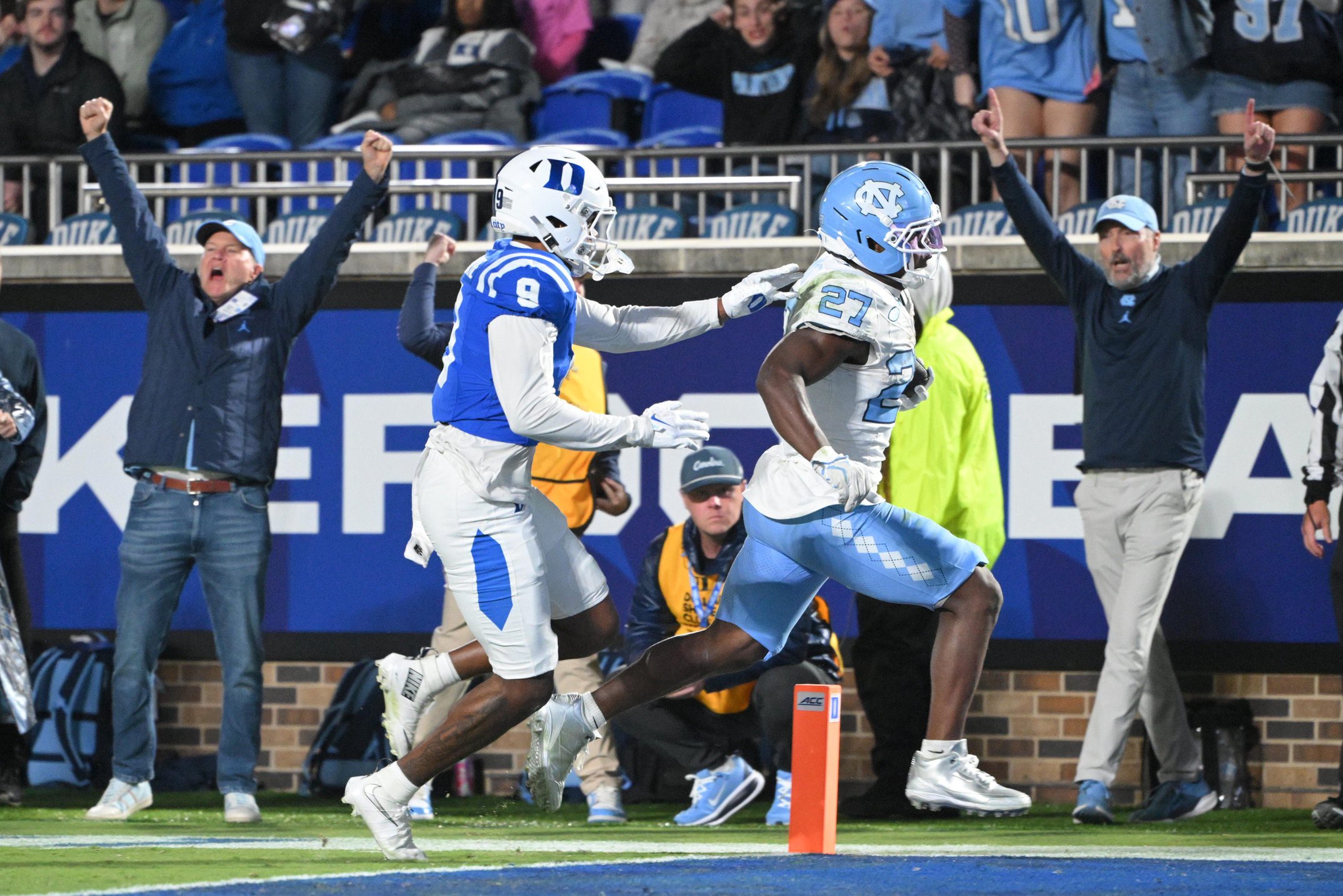 Oct 17, 2026; Durham, North Carolina, USA;  North Carolina Tar Heels running back Jaylen McGill (27) scores a touchdown against Duke Blue Devils saftey Che Ojarikre (9) during the fourth quarter at Wallace Wade Stadium.  Mandatory Credit: Zachary Taft-Imagn Images