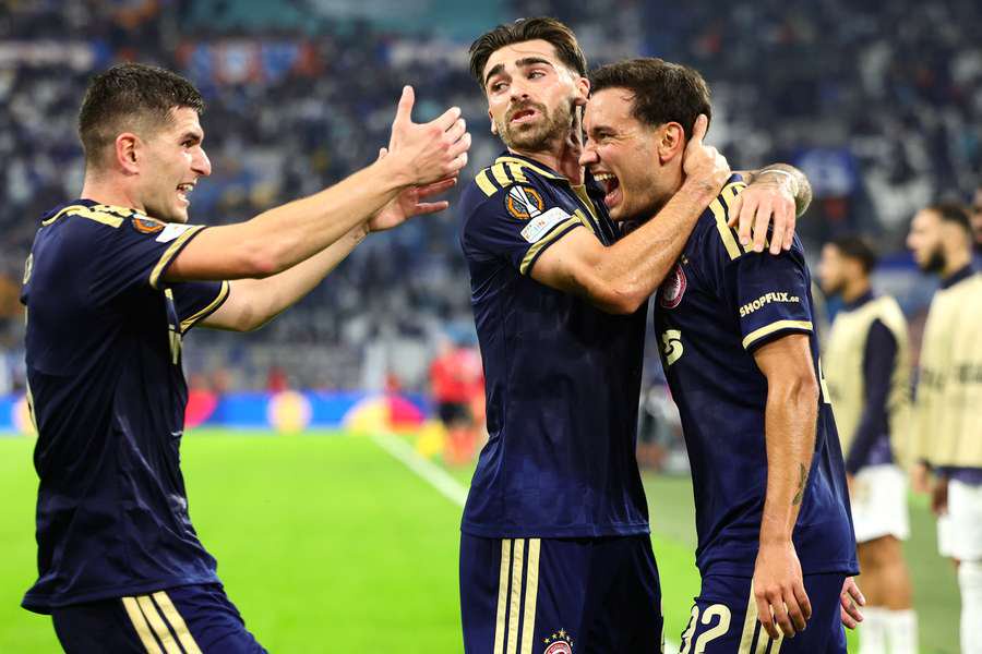 Olympiacos' Santiago Hezze (right) celebrates with teammates after scoring