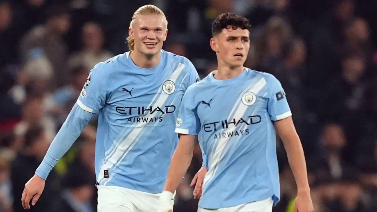 Man City striker Erling Haaland celebrates scoring with Phil Foden