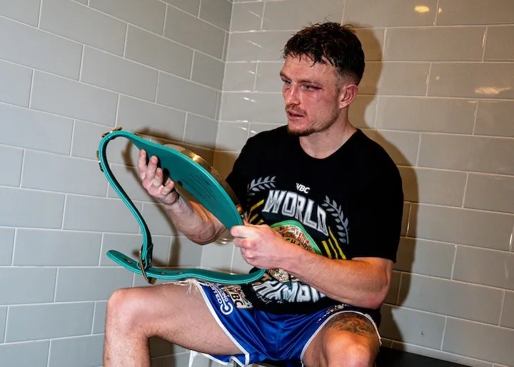 Dalton Smith looks down at the WBC junior welterweight world title soon after knocking out Subriel Matias to win the belt on January 10, 2026.
