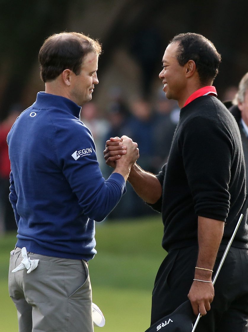 Zach Johnson (L) and Tiger Woods shake hands after Johnson defeated Woods on the first playoff hole during the final round of the Northwestern Mutual World Challenge at Sherwood Country Club on December 8, 2013 in Thousand Oaks, California. (Photo by Stephen Dunn/Getty Images)