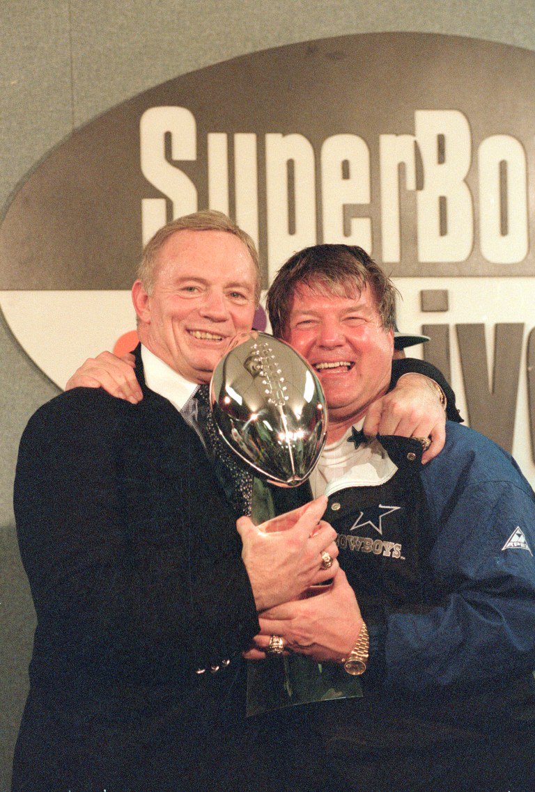 Jerry Jones and Jimmy Johnson holding the Vince Lombardi Trophy after Super Bowl XXVIII.