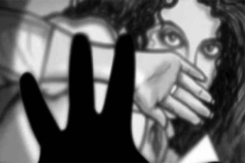 Woman covering face behind silhouette of hand