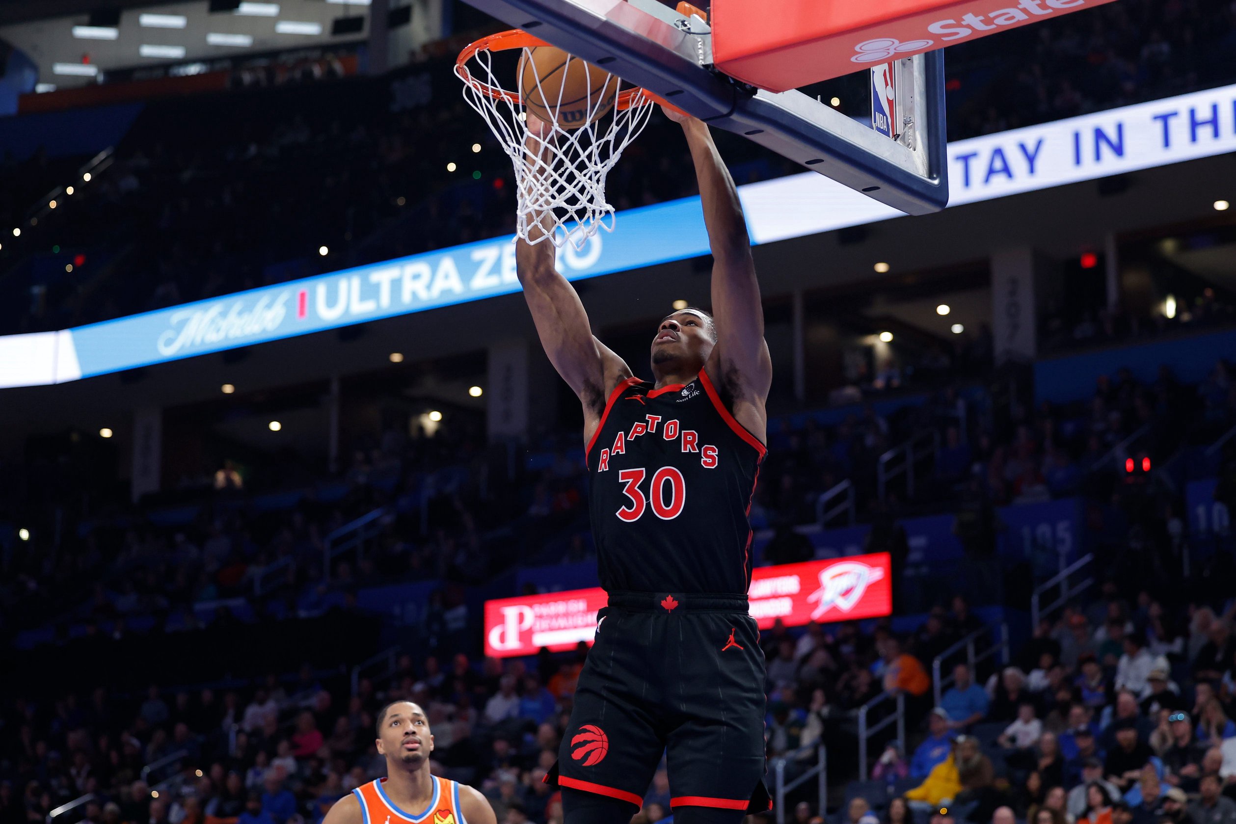 Jan 25, 2026; Oklahoma City, Oklahoma, USA; Toronto Raptors guard Ochai Agbaji (30) dunks against the Oklahoma City Thunder during the second half at Paycom Center. Mandatory Credit: Alonzo Adams-Imagn Images