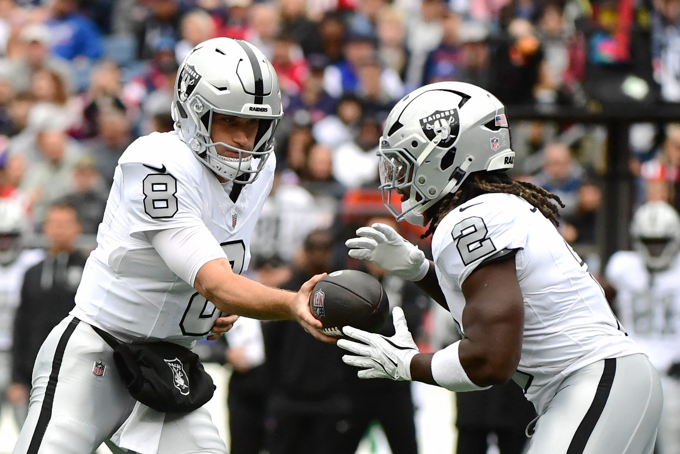 Oct 11, 2026; Foxborough, Massachusetts, USA;  Las Vegas Raiders quarterback Kirk Cousins (8) hands the ball to running back Ashton Jeanty (2) against the New England Patriots during the first quarter at Gillette Stadium.  Mandatory Credit: Bob DeChiara-Imagn Images