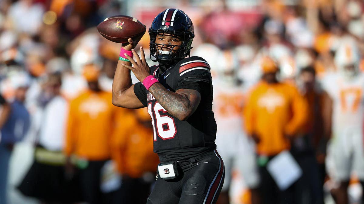 LaNorris Sellers, South Carolina quarterback, looks to pass the ball during a football game.