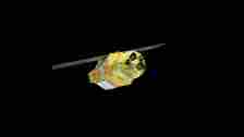  A gif showing a yellow-wrapped spacecraft with solar-panel wings in space. 