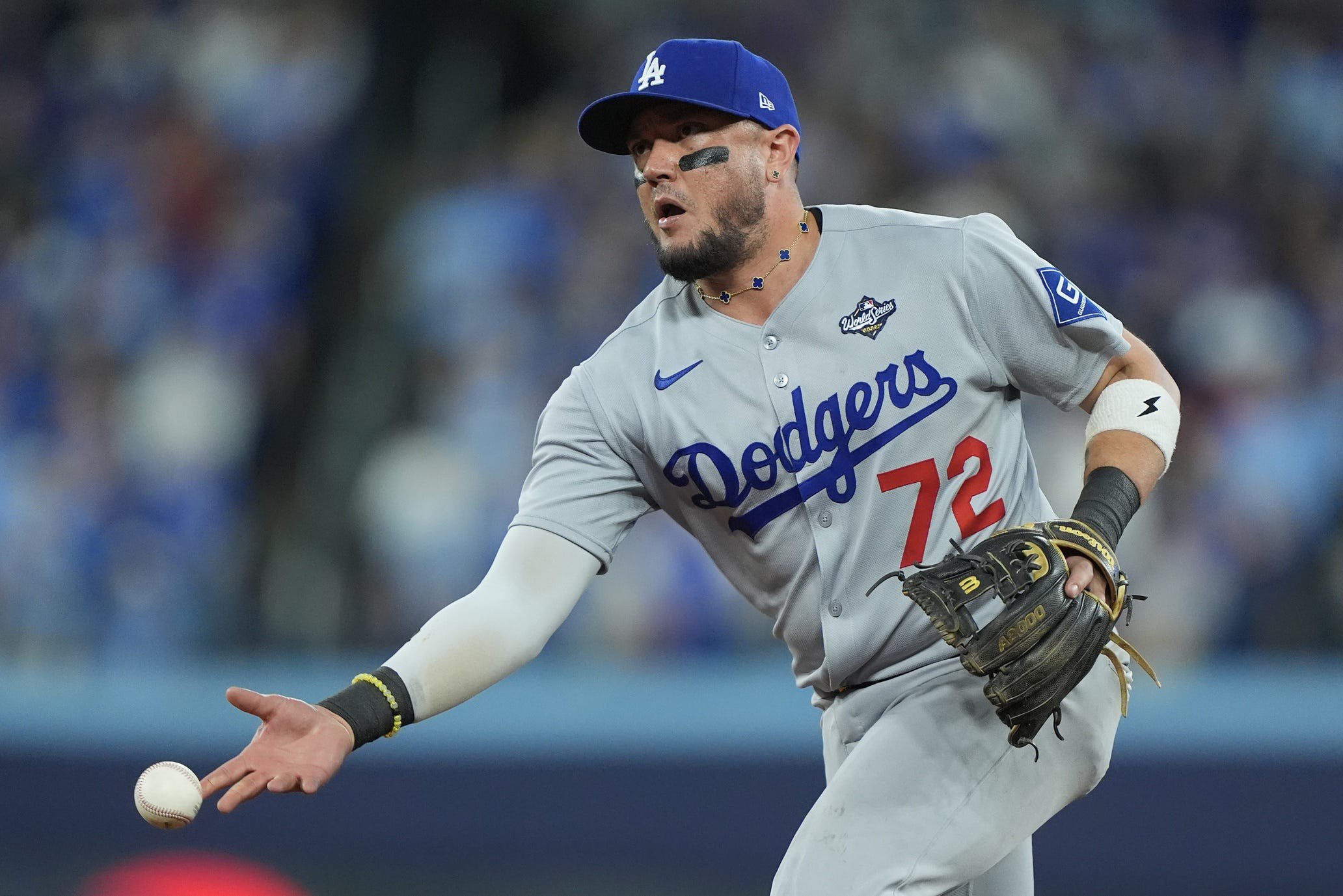 Los Angeles Dodgers second baseman Miguel Rojas throws to first baseman Freddie Freeman for an out against Toronto Blue Jays shortstop Andres Gimenez in the 10th inning during Game 7 of the 2025 World Series at Rogers Centre in Toronto, Ontario, Canada on Nov. 1, 2025.