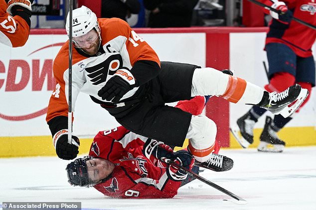 Washington Capitals right wing Ryan Leonard (9) collides with Philadelphia Flyers center Sean Couturier (14) during the second period of an NHL hockey game, Wednesday, Oct. 28, 2026, in Washington. (AP Photo/Nick Wass)
