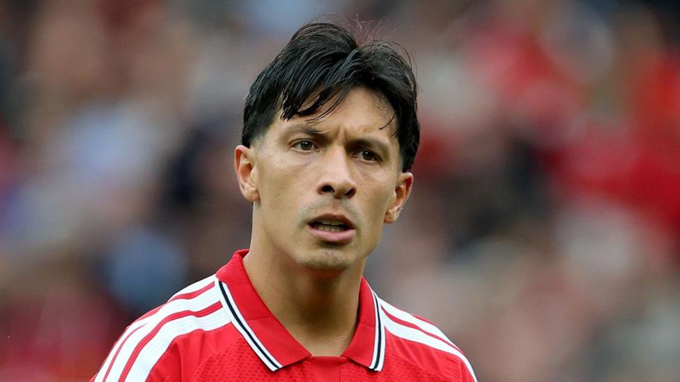 Lisandro Martinez wearing a red Manchester United home shirt