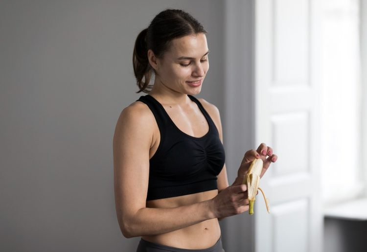 Fit Female Peeling Banana