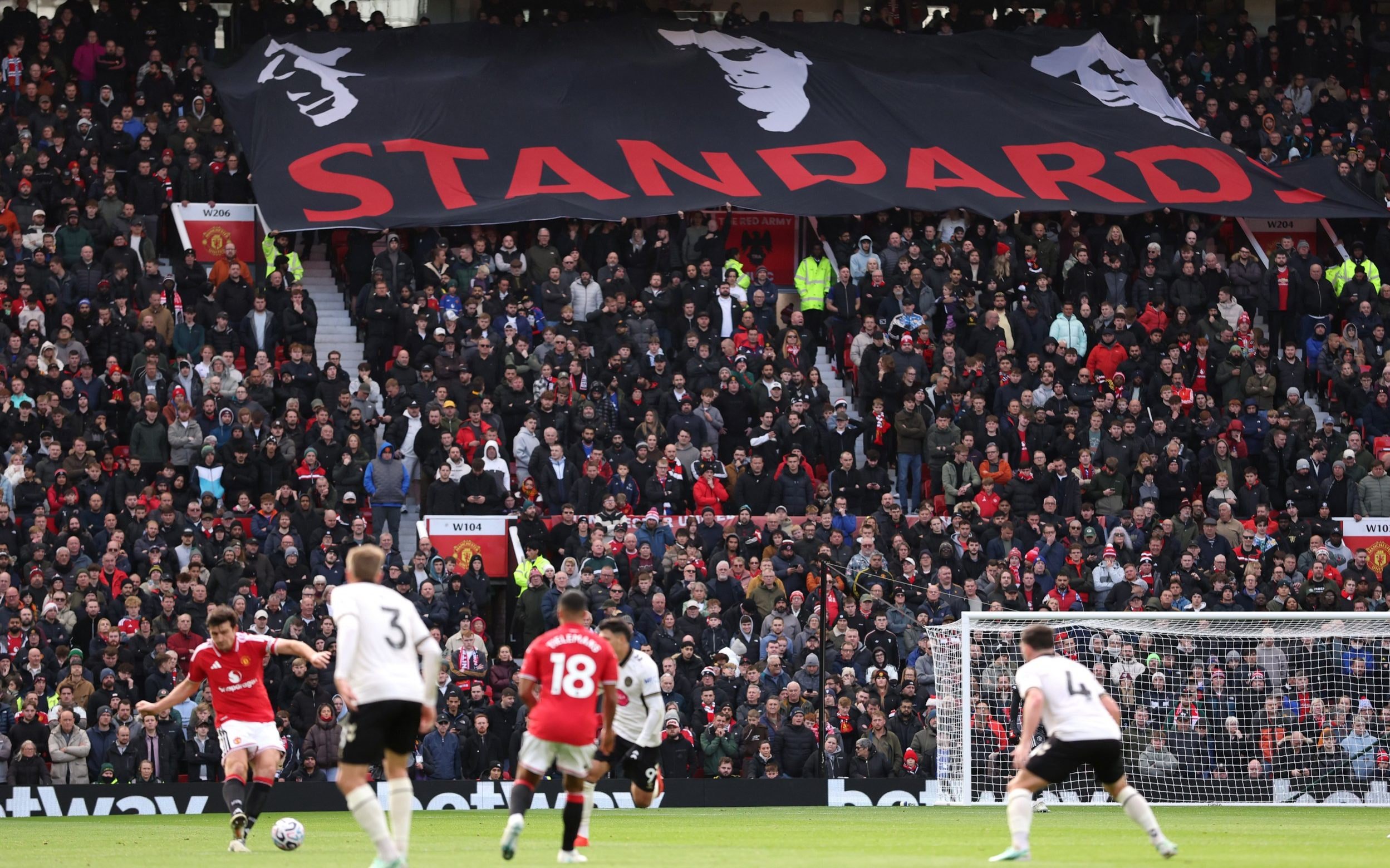 General view inside the stadium as Manchester United fans unveil a banner that reads 'Standards'