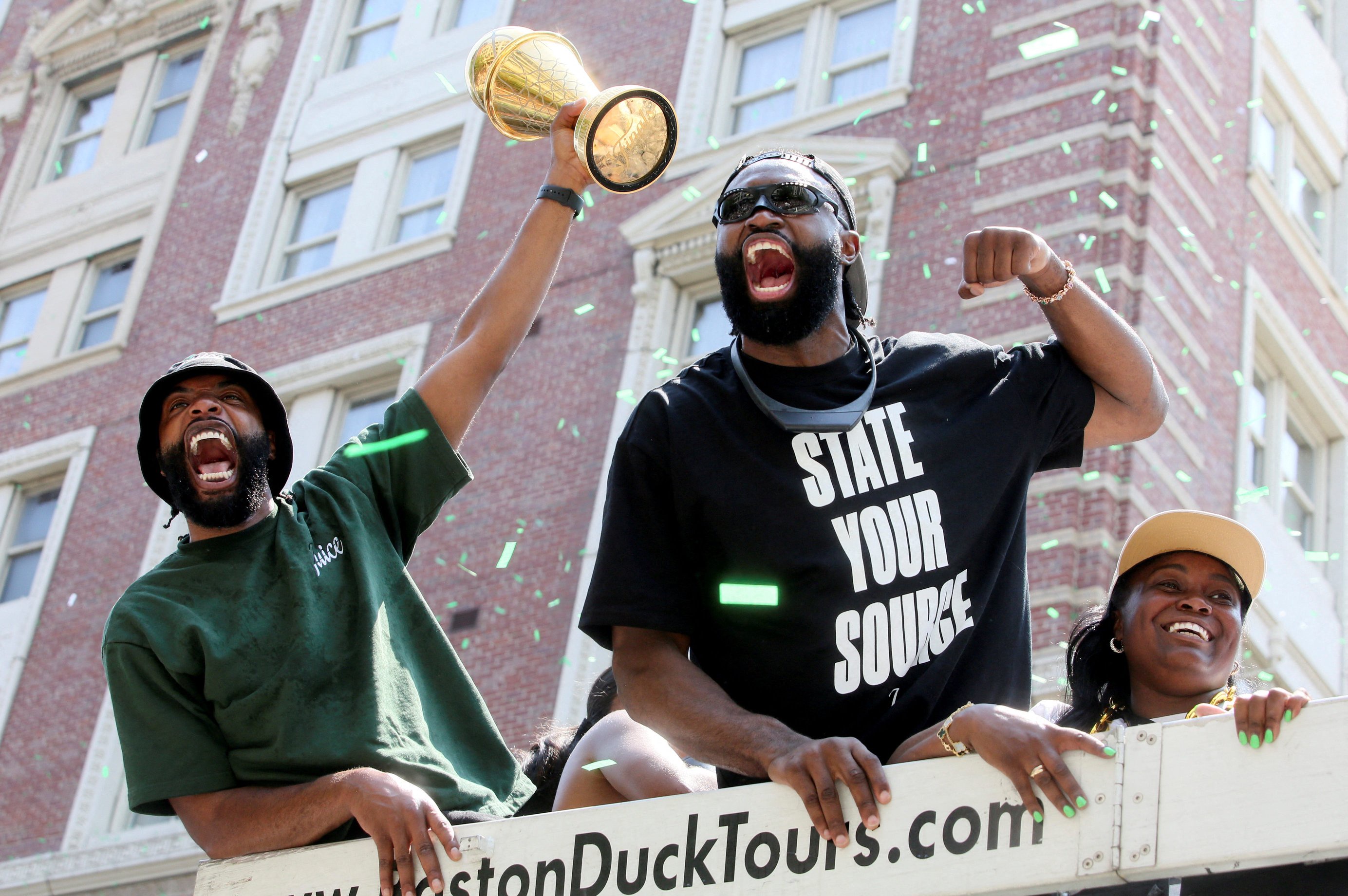 Jaylen Brown holds the trophy during a parade to celebrate the Boston Celtics' 18th NBA Championship in Boston, Massachusetts, U.S. June 21, 2024. REUTERS/Lauren Owens Lambert     TPX IMAGES OF THE DAY